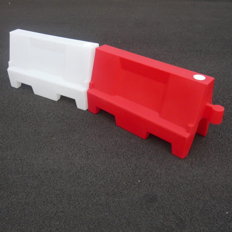 red and white barrier on tarmac