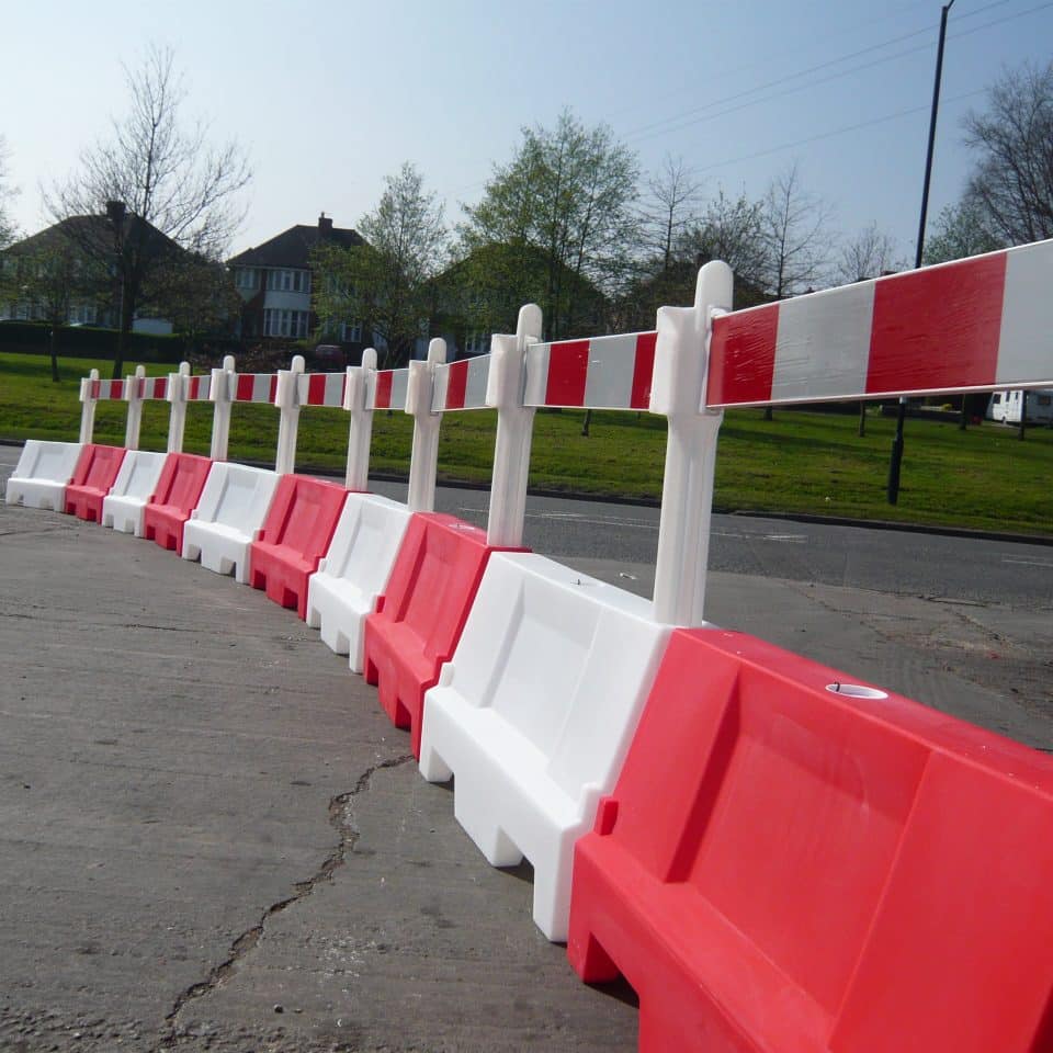 red and white barrier fence posts