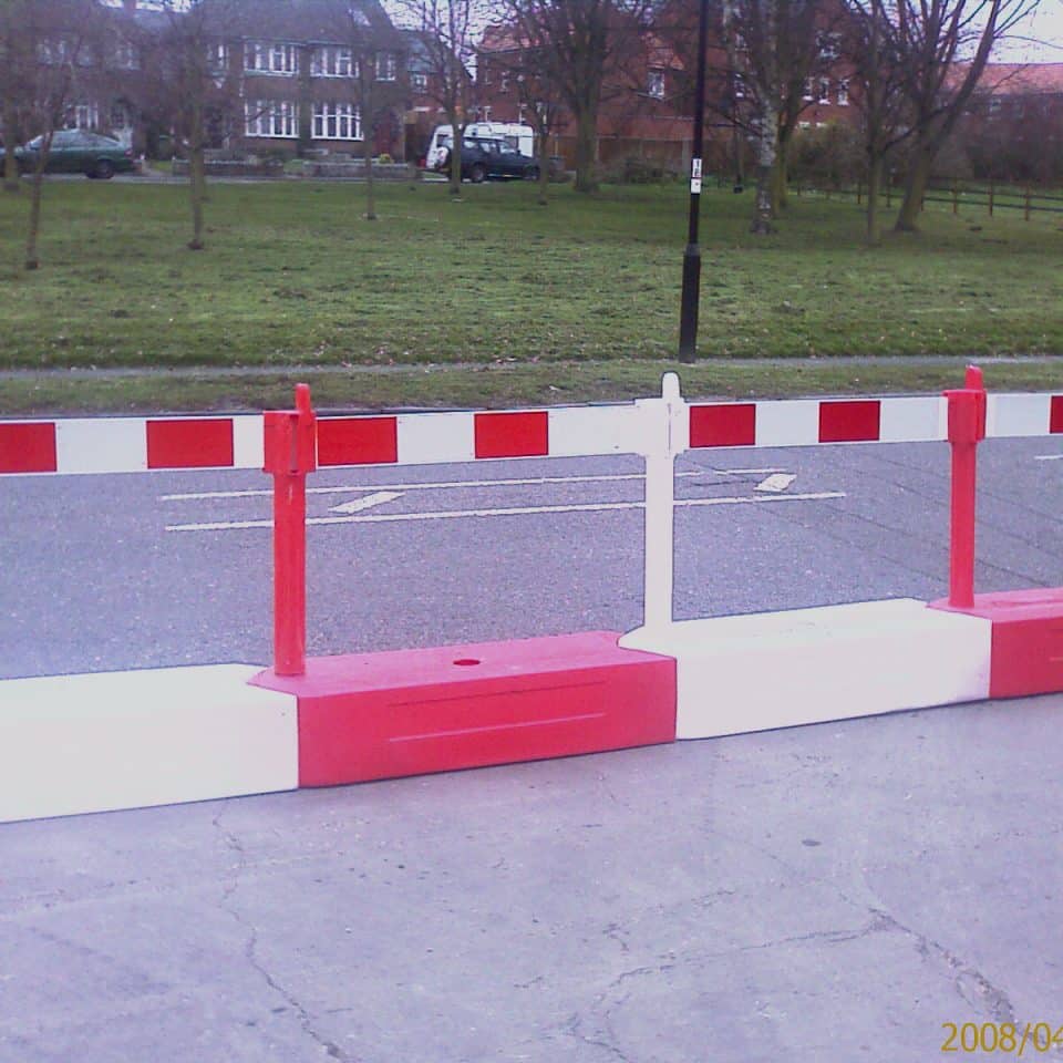 red and white barrier with fences
