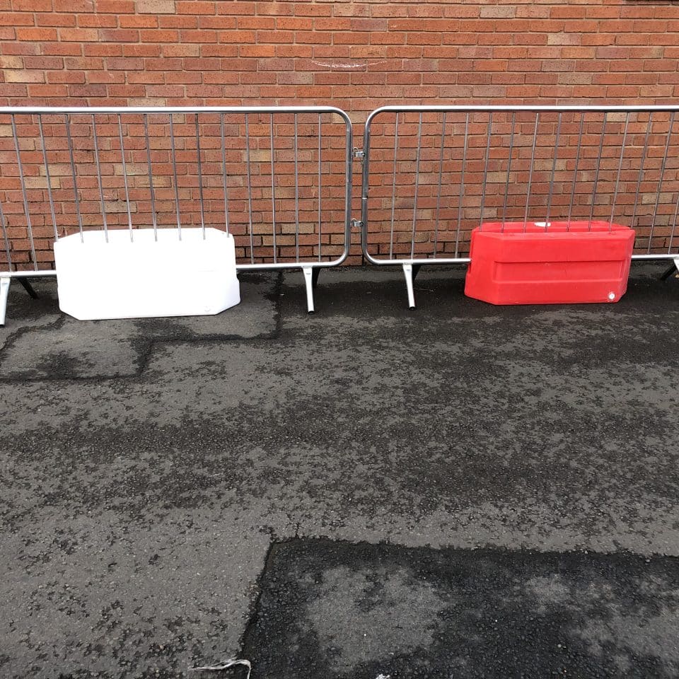 silver fence with red and white low barrier