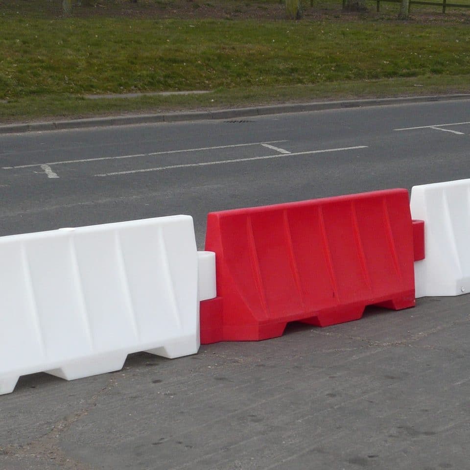 red and white barrier side of road